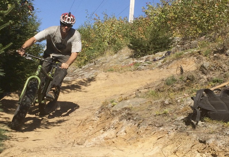 A biker tests the new single-track trail near the “River Road” section in Gorham, NH. In coordination with the Gorham Land Company, Coös Cycling Club volunteers designed, constructed, and provided signage for mountain bikers, runners and hikers. Photo by Kara Hunter.