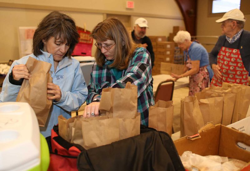 Volunteers prepare Meals-on-Wheels for delivery in Milford, NH. (Photo by Cheryl Senter.)