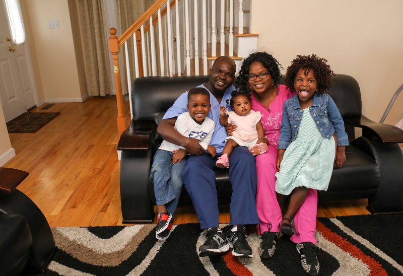 The Ogunbayo family in their Manchester home: Musiliu and Tobi and their children Michael, Liliana and Christiana. (Photo by Cheryl Senter.)