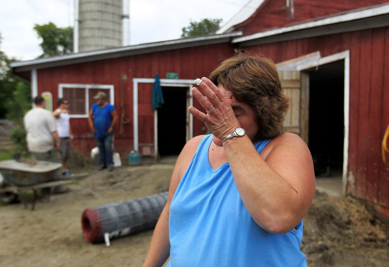Penny Severance, owner of Perley Farm in Royalton, VT, overwhelmed by Hurricane Irene's devastation and her community's generosity. (Photo by Cheryl Senter.)