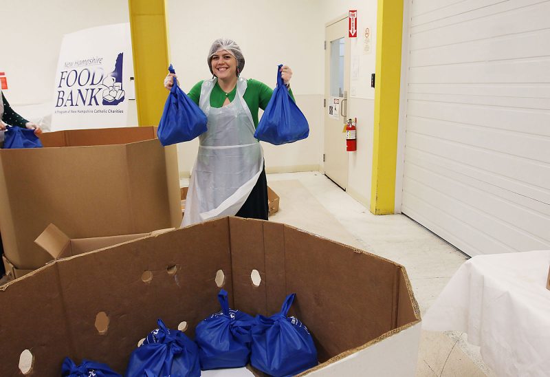 Volunteers at the New Hampshire Food Bank prepare food for distribution.