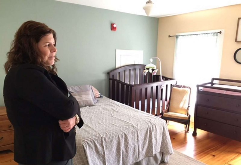 Kerry Norton, R.N., program director at Hope on Haven Hill, gets a room ready for a new resident. The Rochester facility provides residential treatment and recovery support for women who are pregnant or postpartum. (Shawne K. Wickham/Sunday News.)