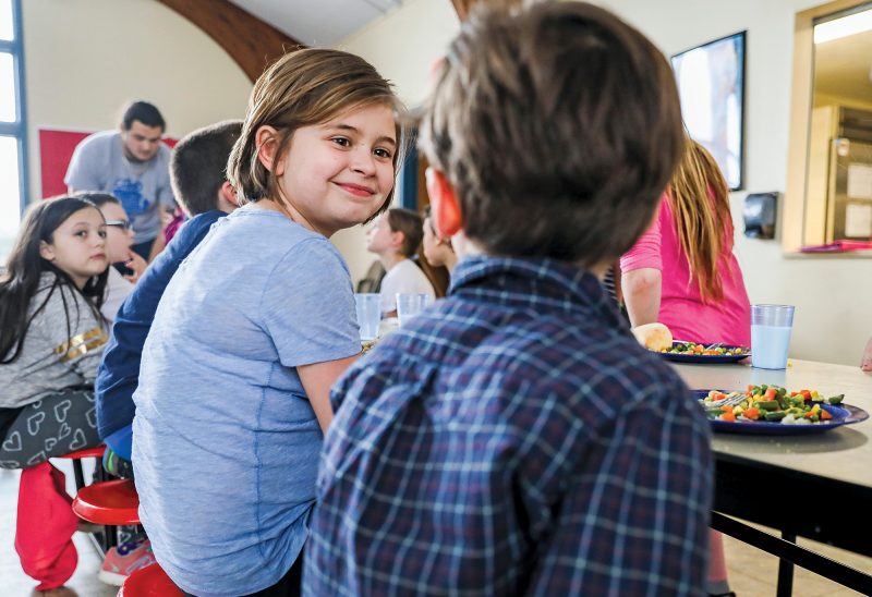 Children at the Laconia Boys and Girls Club enjoy a hot meal prepared in “Mémère’s Kitchen.” (Photo by Cheryl Senter.)