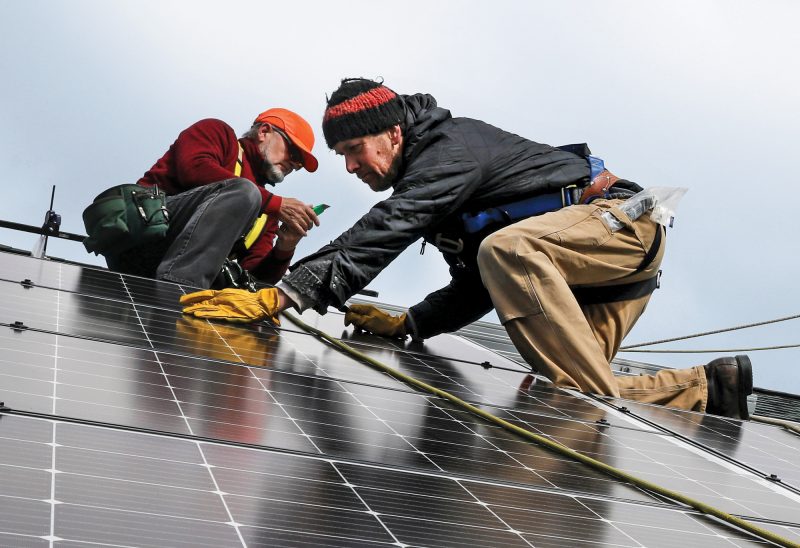 Installing a solar array at Whole Village Family Resource Center in Plymouth. (Photo by Cheryl Senter.)