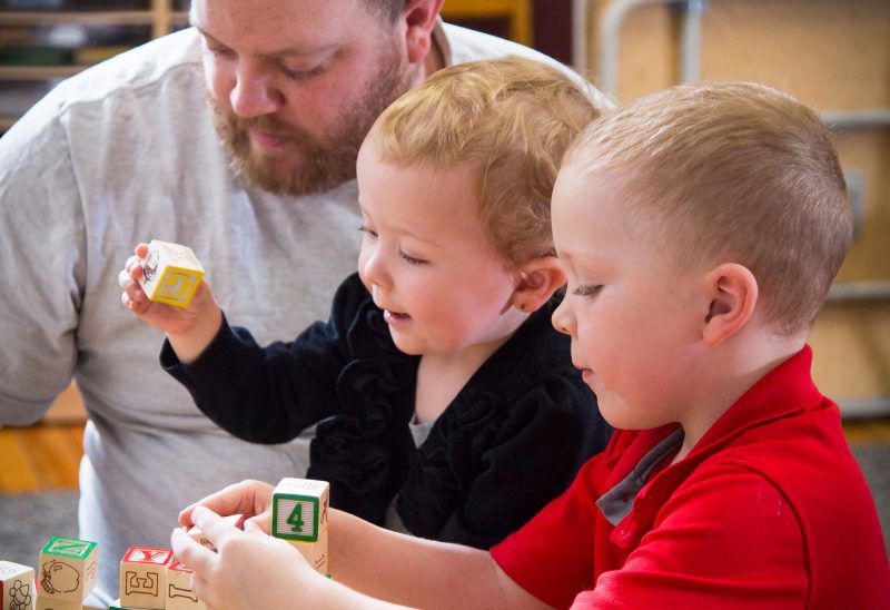 Dad plays with his son and daughter at the Family Resource Center in Gorham, NH. (Courtesy photo).