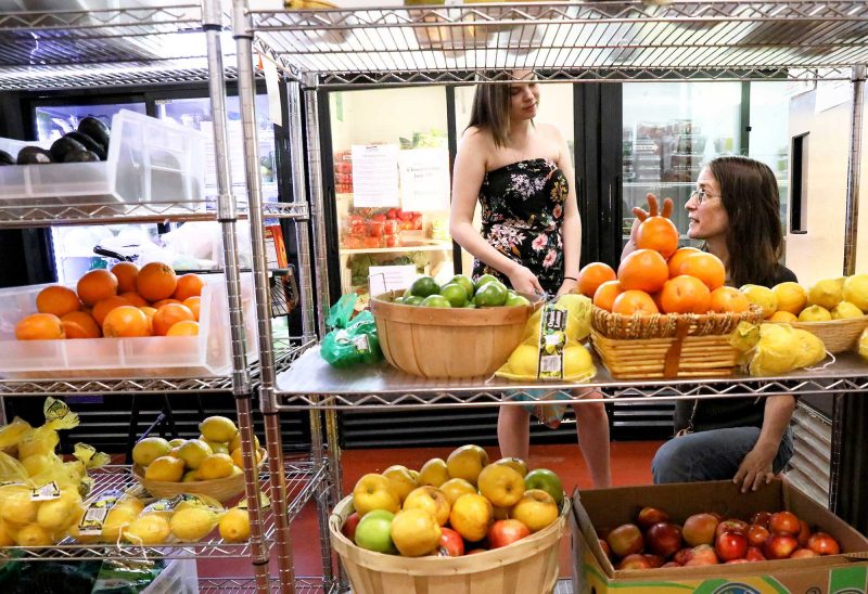 A family shops in the fresh produce section of the Gather Pantry Market in Portsmouth. (Photo by Cheryl Senter.)