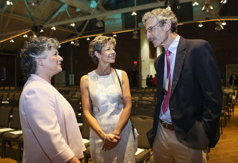 Katie Merrow, vice president of community impact (left) with Laura Rauscher, director of development and philanthropy services (center) talking with Steven Hahn of Hillsborough, chair of Monadnock regional advisory board. (Photo by Cheryl Senter.)