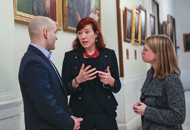 ACLU-NH Policy Director Jeanne Hruska (center) confers with colleagues Gilles Bissonnette and Devon Chafee at the State House. (Photo by Cheryl Senter.)