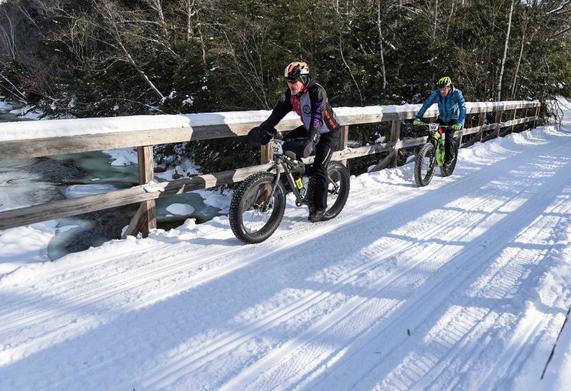 Fat-bike racers crossing Moose Brook in Gorham, NH. (Photo by Joe Klementovich.)