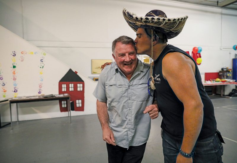 Justin Fuller (right), an Austin17 House volunteer, shows his appreciation for Mark Anderson. (Photo by Cheryl Senter.)