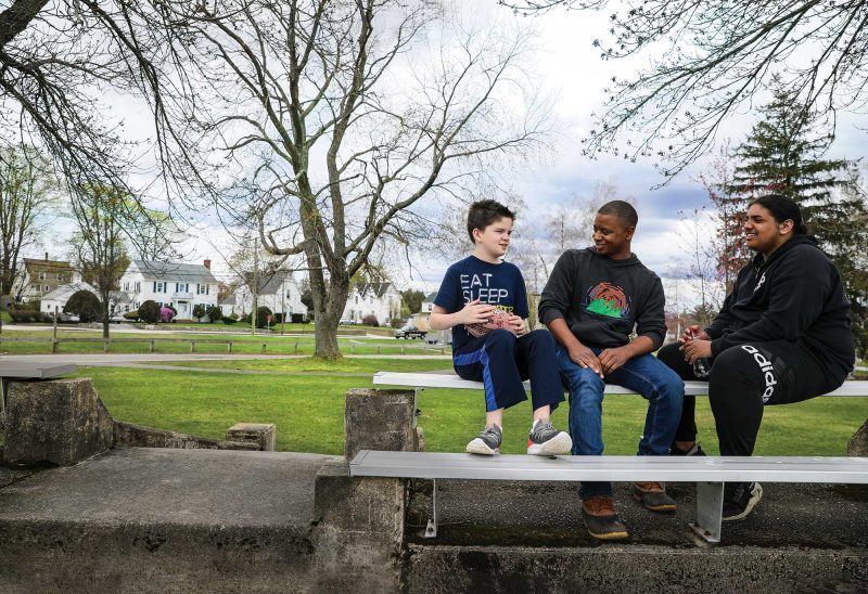 Brandon Pierre (center) with Jayson (left) and Arandea, two of the boys whom Brandon mentors through the Mayhew Program. (Photo by Cheryl Senter.)