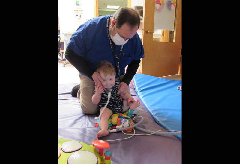 Respiratory therapist John Gallagher caring for a young resident at the Cedarcrest Center for Children with Disabilities (Courtesy photo).
