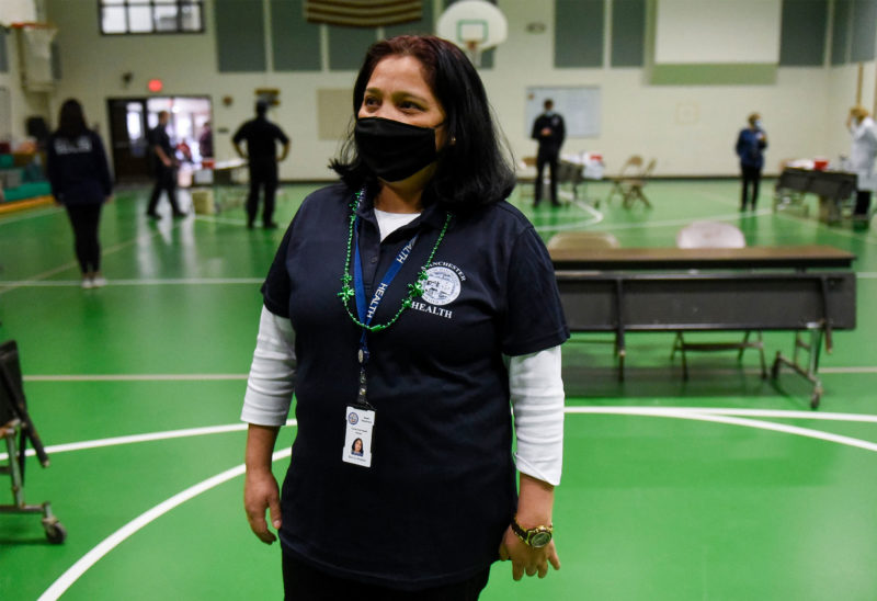 Community health worker Bishnu Khadka, shown at a vaccination clinic at Beech Street School in Manchester last week, said people are excited to get the vaccine. (Photo by Thomas Roy, courtesy of Union Leader.)