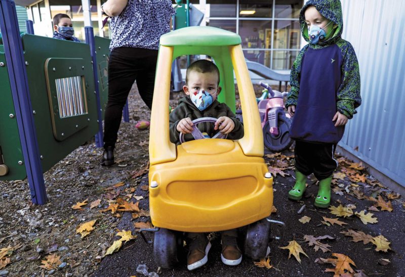 A family plays outside at Cross Roads House in Portsmouth. (Photo by Cheryl Senter.)