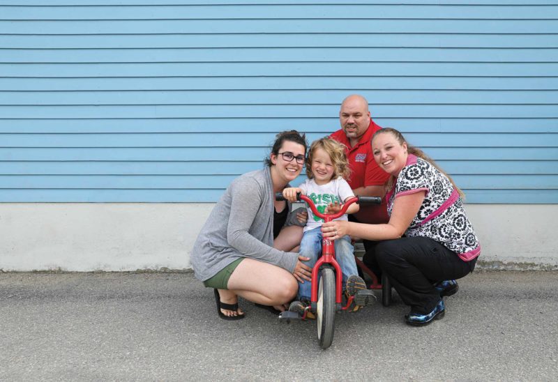 Three-year-old Rawson Phillips at the Country Day School in Colebrook with (clockwise from left) teacher Katelyn Ryder, and parents Morgan and Devon Phillips. (Photo by Cheryl Senter.)