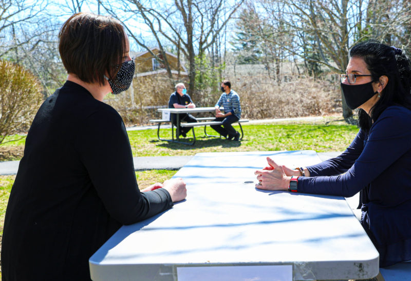 Seacoast Mental Health Center providers meet with clients outdoors at the organization’s Portsmouth location. (Photo by Cheryl Senter.)