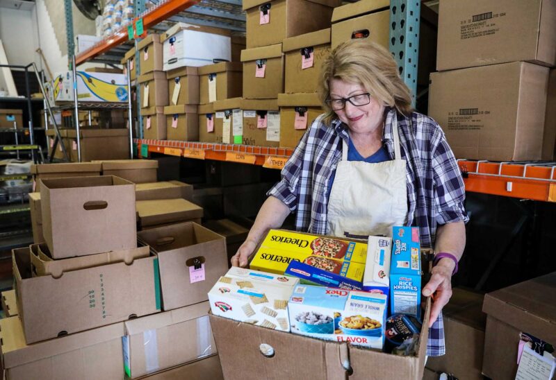 A volunteer helps at Gather Pantry Market in Portsmouth. (Photo by Cheryl Senter.)