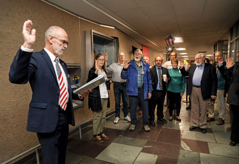 Poll workers are sworn in for duty on Election Day in Milford. (Photo by Cheryl Senter.)