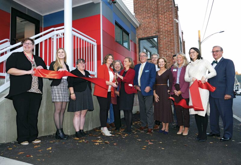 Waypoint staff and community members celebrate Waypoint’s new emergency overnight shelter in Manchester at an event in October. (Courtesy photo.)