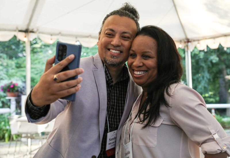 Tanisha Johnson of Community Action Partnership of Strafford County (right) with Sandeep Bikram Shah, senior program officer (left). (Photo by Cheryl Senter.)