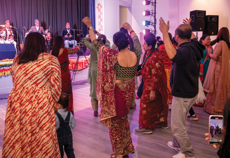 Community members dance during a celebration of Deepwali at the Concord City Wide Community Center