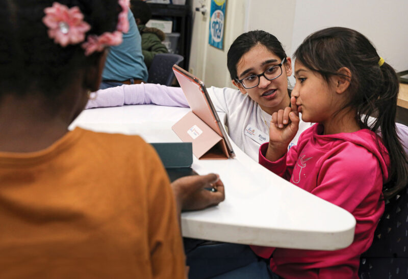 Riyah Patel tutoring a student using an iPad