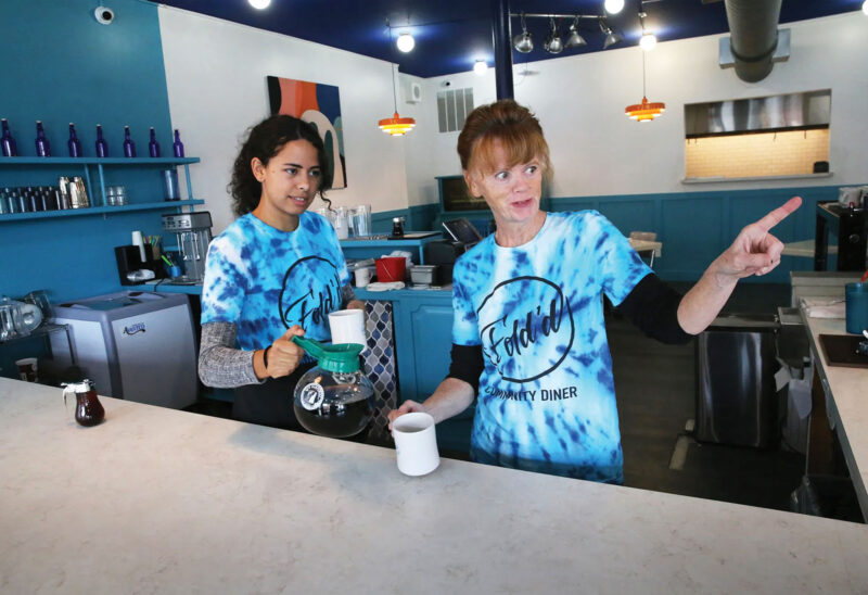 Two women working the counter of Fold'd restaurant