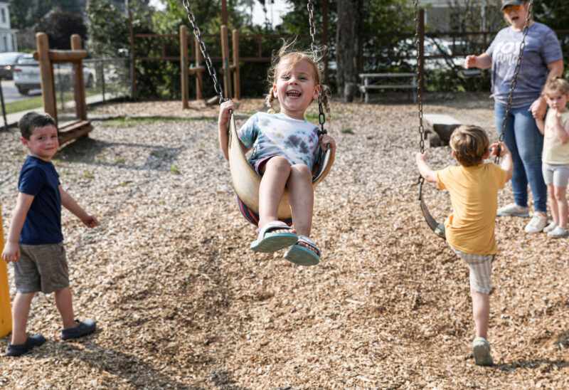 Students at the Rochester Child Care Center enjoy time outside on the playground (Photo by Cheryl Senter.)